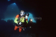 Female scuba diver entering cave complex. Female scuba diver entering cave complex.