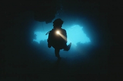 Scuba diver entering cave complex. Scuba diver entering cave complex.