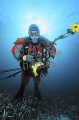 Diver with underwater camera equipment and wearing drysuit for cold water conditions. Diver with underwater camera equipment and wearing drysuit for cold water conditions.