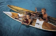 Boys from papua new guinea island village in canoes. Boys from papua new guinea island village in canoes.