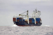Cargo ship travelling at sea loaded with containers. Cargo ship travelling at sea loaded with containers.
