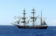 Schooner at sea with partially set sails. Schooner at sea with partially set sails.