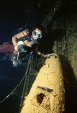 Diver with torpedo in hold on the Heian Maru, Japanese WW II shipwreck. Diver with torpedo in hold on the Heian Maru, Japanese WW II shipwreck.