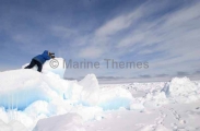 Inuit hunter scanning sea ice for seals from high vantage point created by pressure from wind and tides. Inuit hunter scanning sea ice for seals from high vantage point created by pressure from wind and tides.