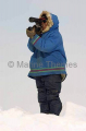 Inuit hunter scanning sea ice for seals from high vantage point created by pressure from wind and tides. Inuit hunter scanning sea ice for seals from high vantage point created by pressure from wind and tides.
