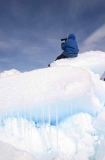Inuit hunter scanning sea ice for seals from high vantage point created by pressure from wind and tides. Inuit hunter scanning sea ice for seals from high vantage point created by pressure from wind and tides.