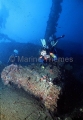 Diver over small tank of deck of the Nippo Maru, Japanese WW II shipwreck. Diver over small tank of deck of the Nippo Maru, Japanese WW II shipwreck.