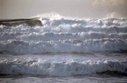Storm waves rolling in on sandy beach during El Nino effect. Storm waves rolling in on sandy beach during El Nino effect.