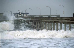 Storm waves rolling in on pier during El Nino effect. Storm waves rolling in on pier during El Nino effect.