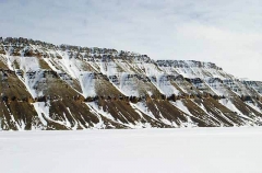Snow bound cliffs meeting sea ice on ocean edge. Snow bound cliffs meeting sea ice on ocean edge.
