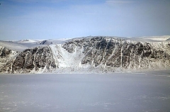 Snow covered seaside cliffs and sea ice. Snow covered seaside cliffs and sea ice.