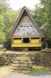 Traditional Bai meeting hall in Palau, Micronesia, with story board artwork on gables containing ocean themes including fish and sharks.