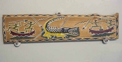 Traditional story board carving from Palau, Micronesia, showing hunters attacking large Saltwater Crocodile (Crocodylus porosus) Traditional story board carving from Palau, Micronesia, showing hunters attacking large Saltwater Crocodile (Crocodylus porosus)