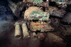 Large artillery shells and land mines stacked in forward hold of the San Francisco Maru, Japanese WW II shipwreck.