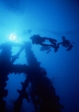 Divers ascending superstructure on shipwreck. Divers ascending superstructure on shipwreck.
