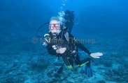 Scuba divers exploring coral reef.