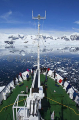 Ice breaker, with tourists on the bow, moving through channel littered with brash ice. Ice breaker, with tourists on the bow, moving through channel littered with brash ice.