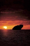 Shipwreck of the Runic on Middleton Reef, Coral Sea, at sunset.