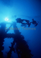 Divers ascending superstructure on shipwreck. Divers ascending superstructure on shipwreck.