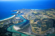 Aerial of coastal fishing town on cape with river and estuary system. Aerial of coastal fishing town on cape with river and estuary system.
