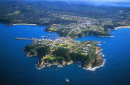 Aerial of coastal fishing town on cape with boat harbor. Aerial of coastal fishing town on cape with boat harbor.
