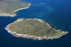 Island off promontory at mouth of large bay with sand bars and seagrass beds. Island off promontory at mouth of large bay with sand bars and seagrass beds.