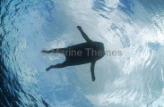 Sharks eye view of a man floating on a boogy board, similar in outline to large turtle which are preyed upon by sharks. Sharks eye view of a man floating on a boogy board, similar in outline to large turtle which are preyed upon by sharks.
