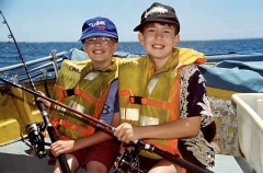 Boys fishing from small boat. Boys fishing from small boat.