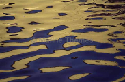 Blue and gold wave reflections on ocean surface. Blue and gold wave reflections on ocean surface.