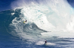 Tow-in surfer and jet ski at Peahi (Jaws) Tow-in surfer and jet ski at Peahi (Jaws)