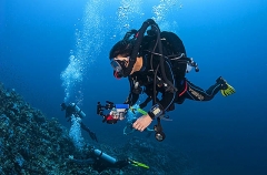 Diver, with camera, using a closed circuit rebreather, Drager unit. Diver, with camera, using a closed circuit rebreather, Drager unit.