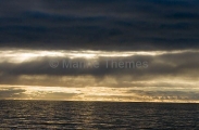 Afternoon sun and clouds over open ocean. Afternoon sun and clouds over open ocean.